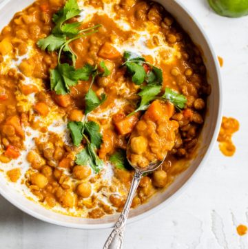 chickpeas and lentils in a bowl topped with cilantro