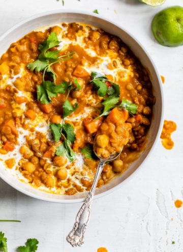 chickpeas and lentils in a bowl topped with cilantro