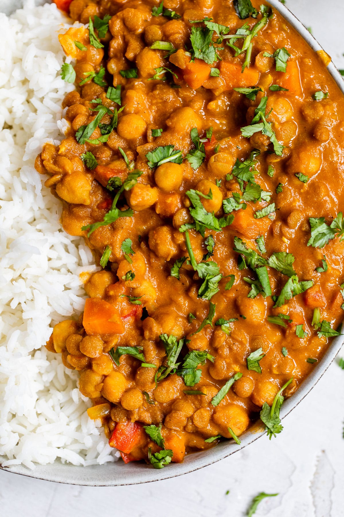 close up of cooked lentils and chickpeas in a curry sauce