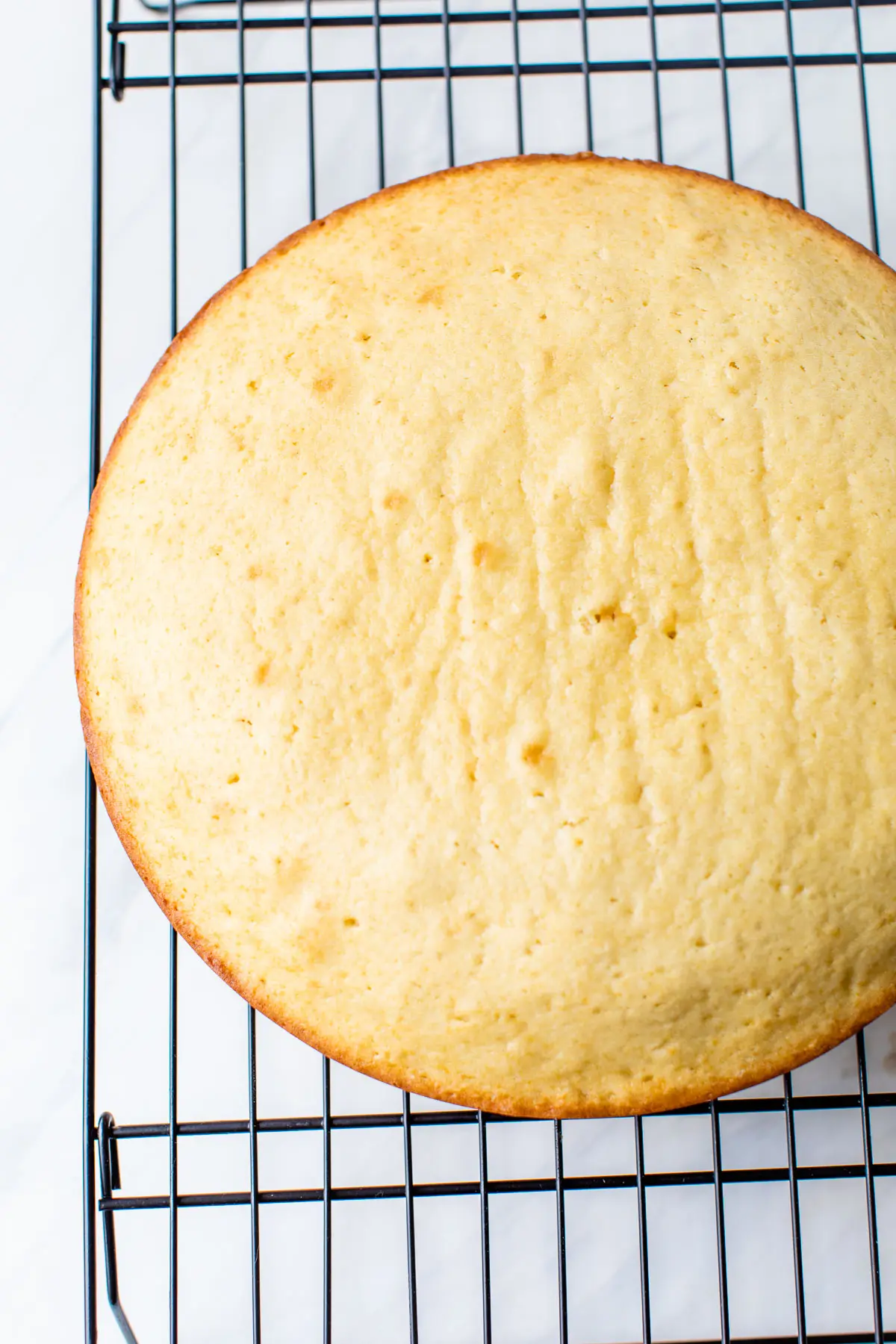 a round cake on a cooling rack
