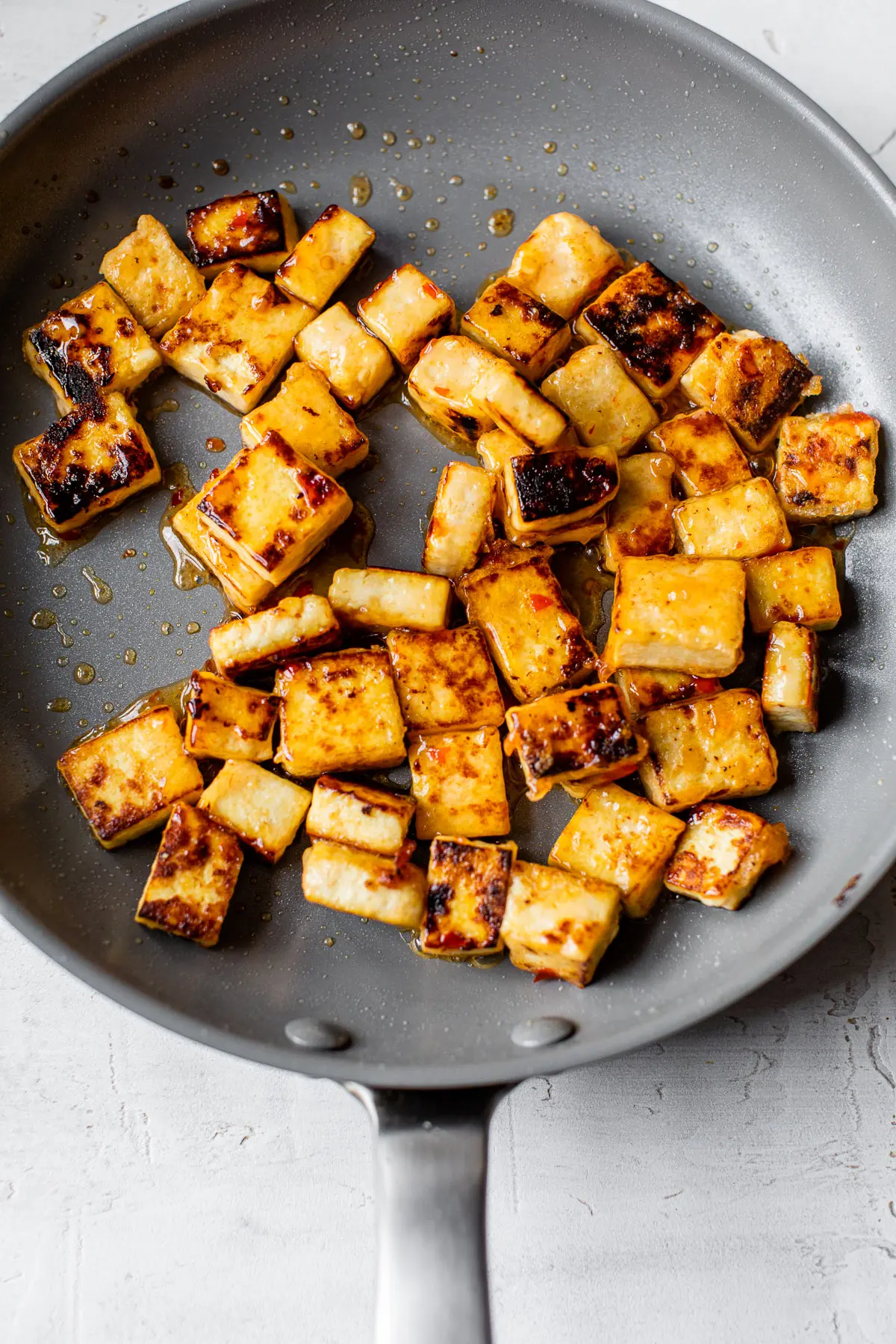 crispy pan-fried tofu in a skillet