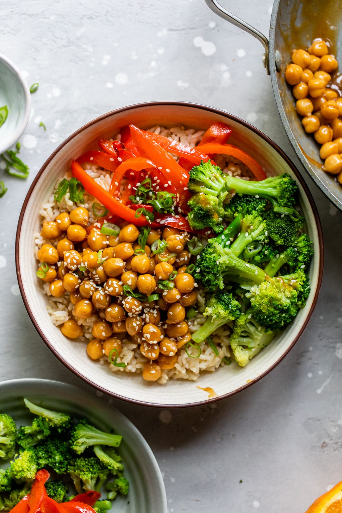 bowls with rice, chickpeas, broccoli, and bell pepper