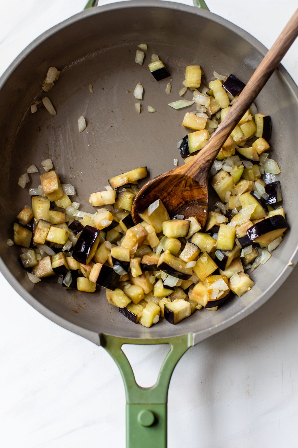 cooked diced eggplant and onion in a skillet
