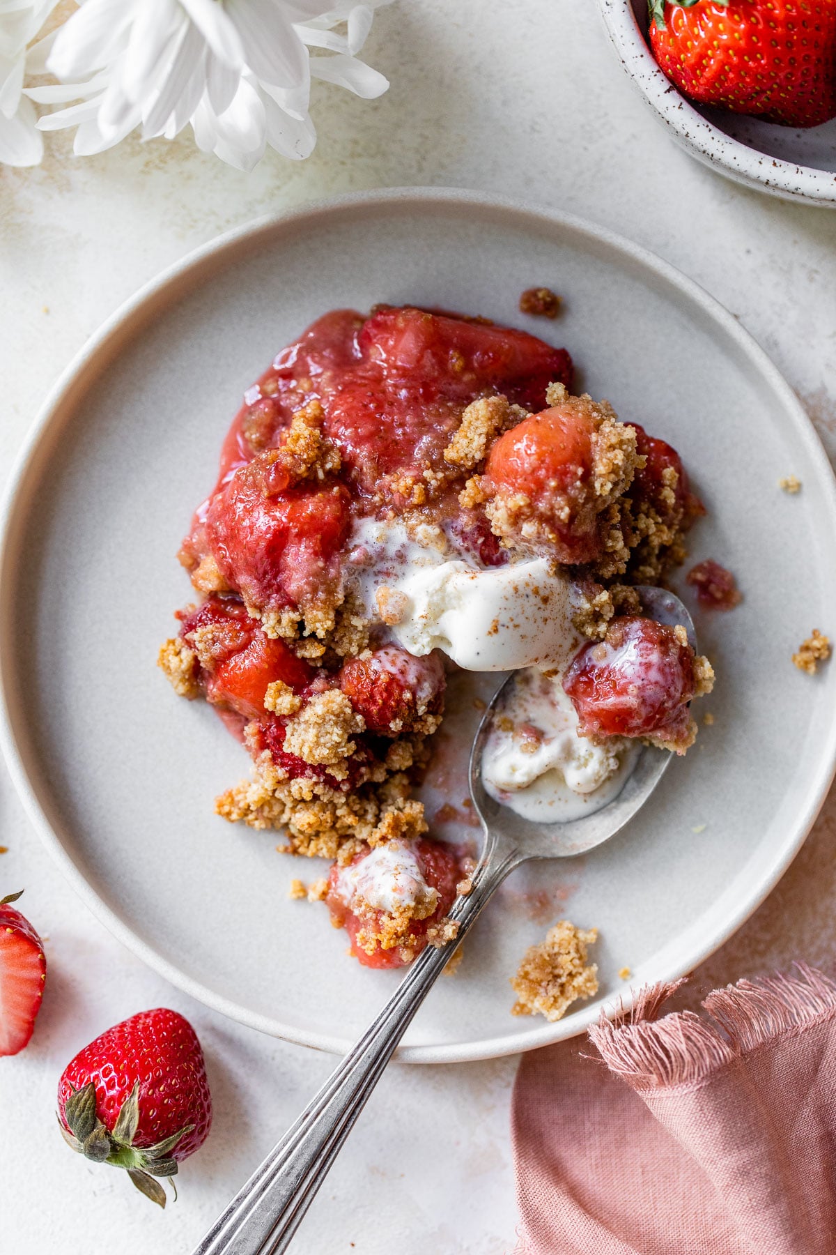 cooked strawberries on a plate topped with almond flour and brown sugar