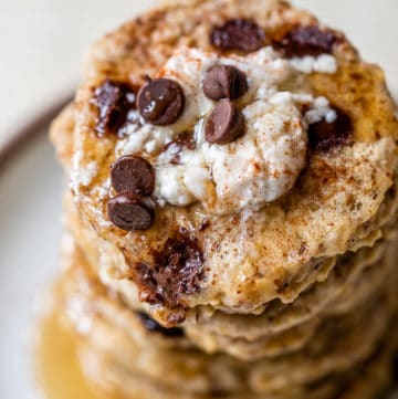 a stack of pancakes topped with yogurt and chocolate chips