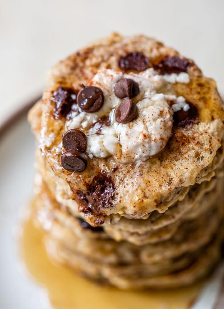 a stack of pancakes topped with yogurt and chocolate chips
