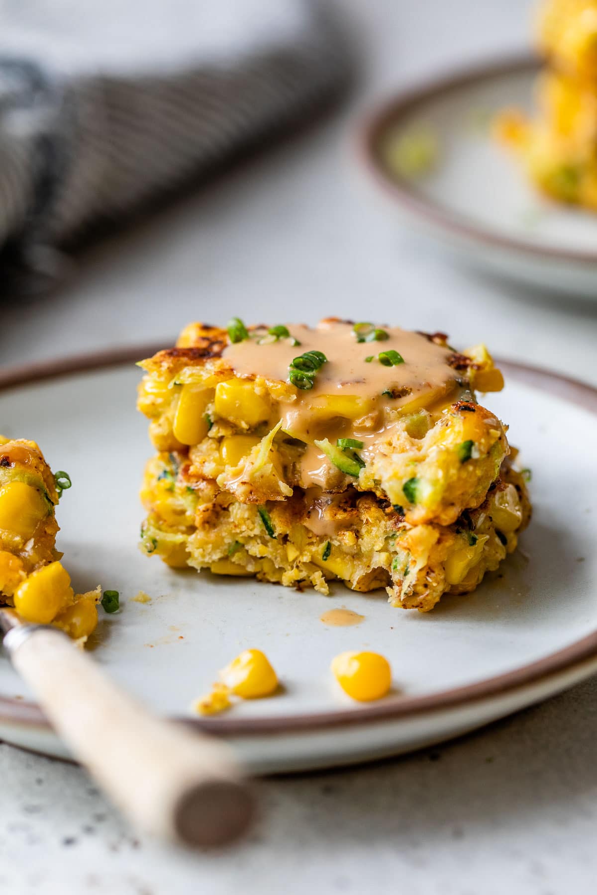 a zucchini corn fritter with a bite taken out of it