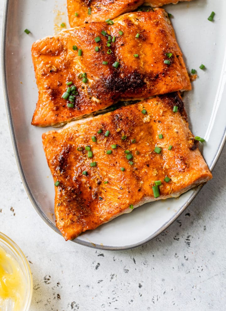 salmon fillets on a platter sprinkled with chives