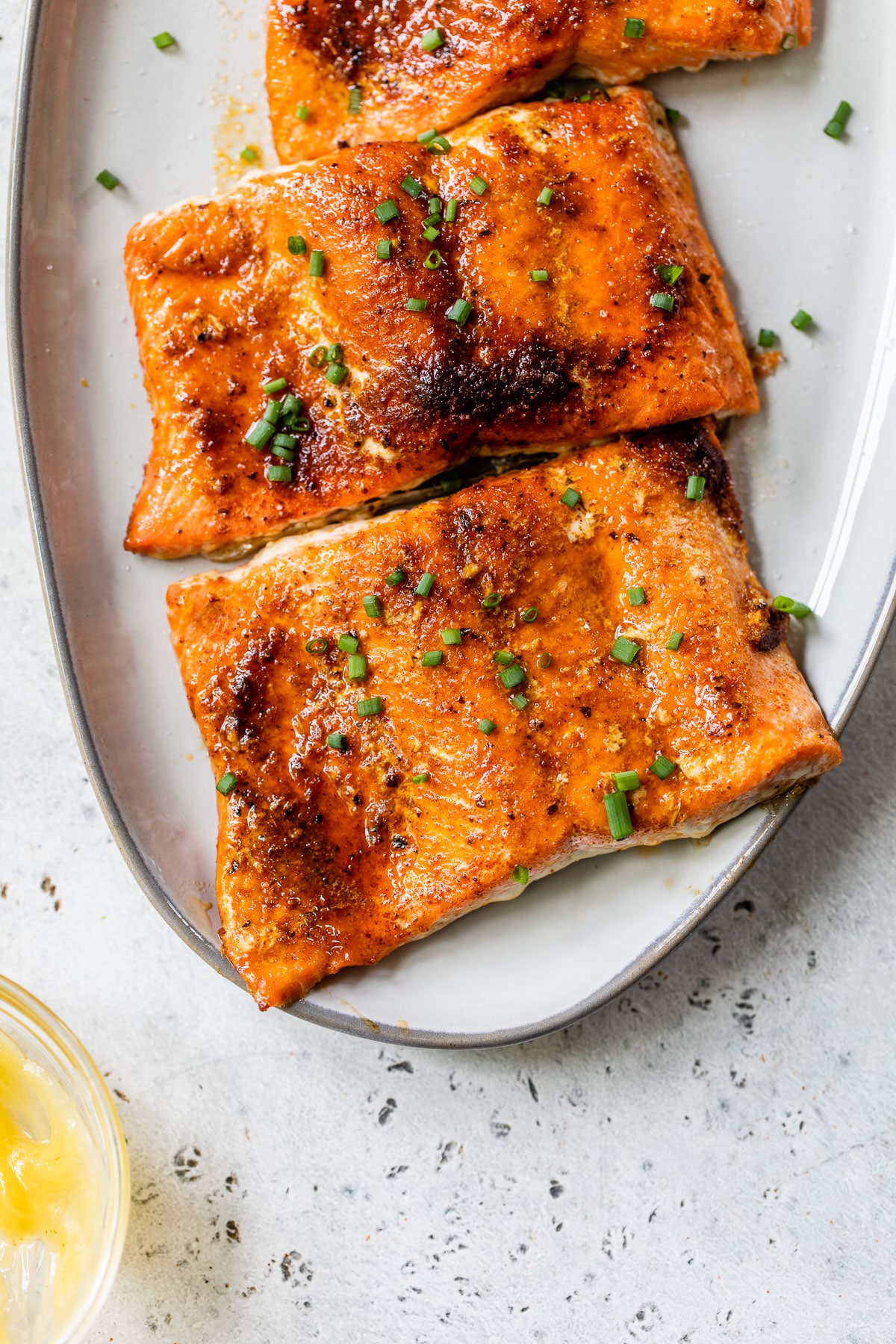 salmon fillets on a platter sprinkled with chives