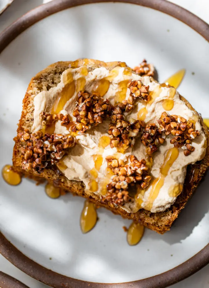 a slice of bread topped with whipped cream and toasted buckwheat