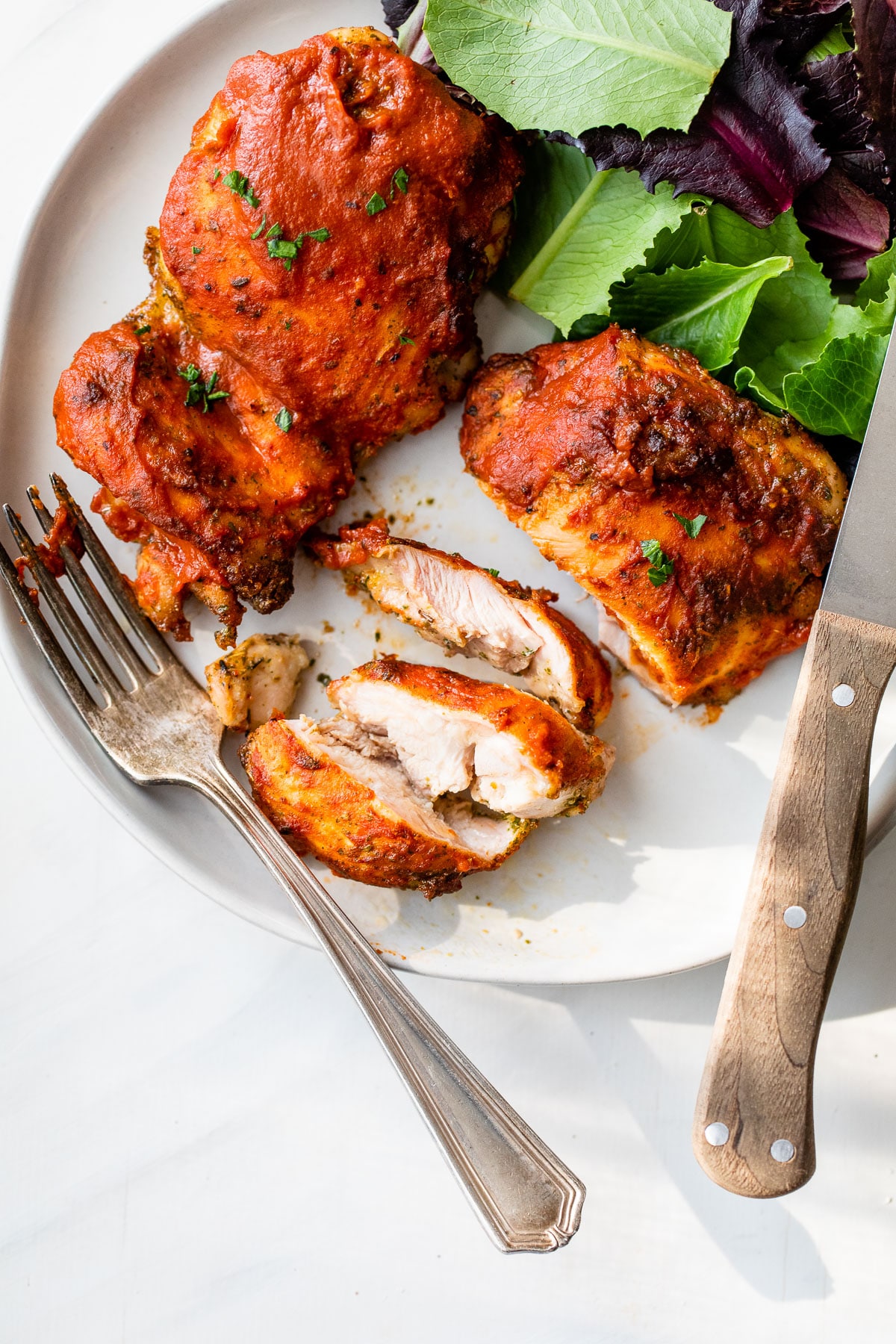 a sliced baked chicken thigh