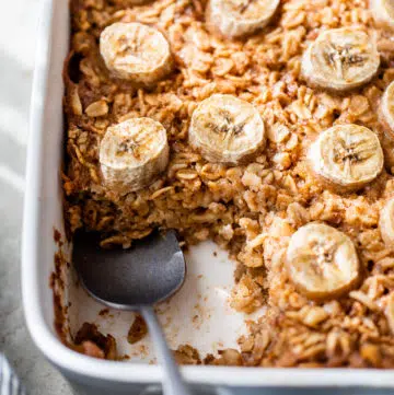 oatmeal in a baking dish topped with sliced banana