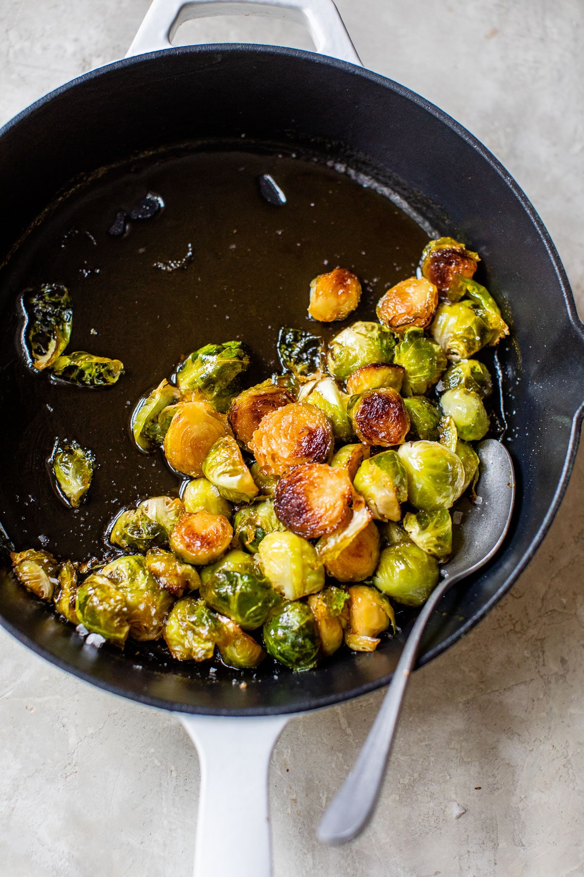 cast iron skillet with cooked brussels sprouts