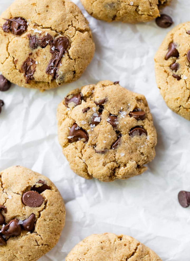 several cookies with chocolate chips on parchment paper