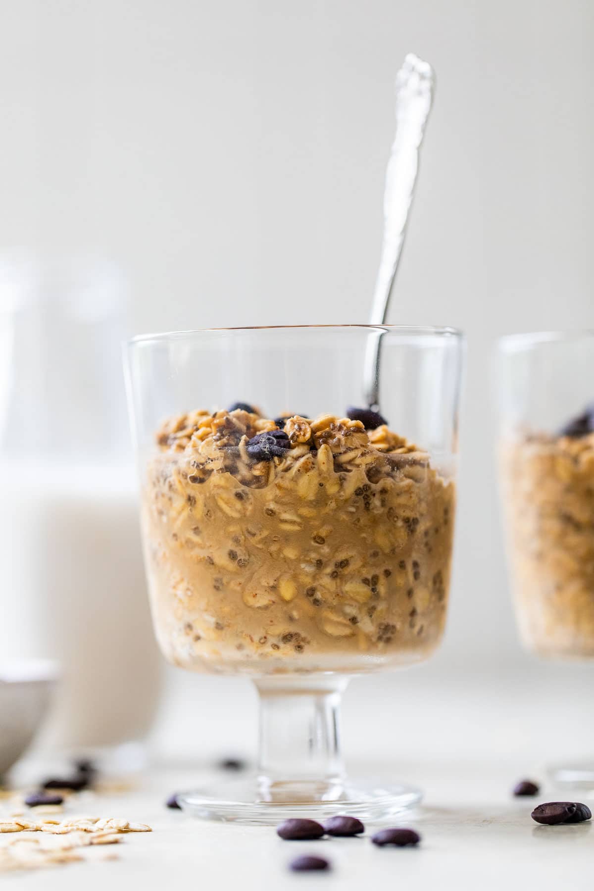 coffee overnight oats in a jar with a spoon sticking out