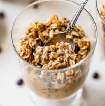 oats in a glass jar with a spoon in it