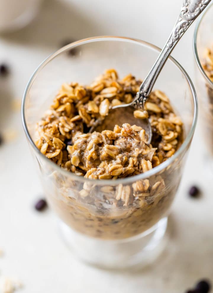 oats in a glass jar with a spoon in it