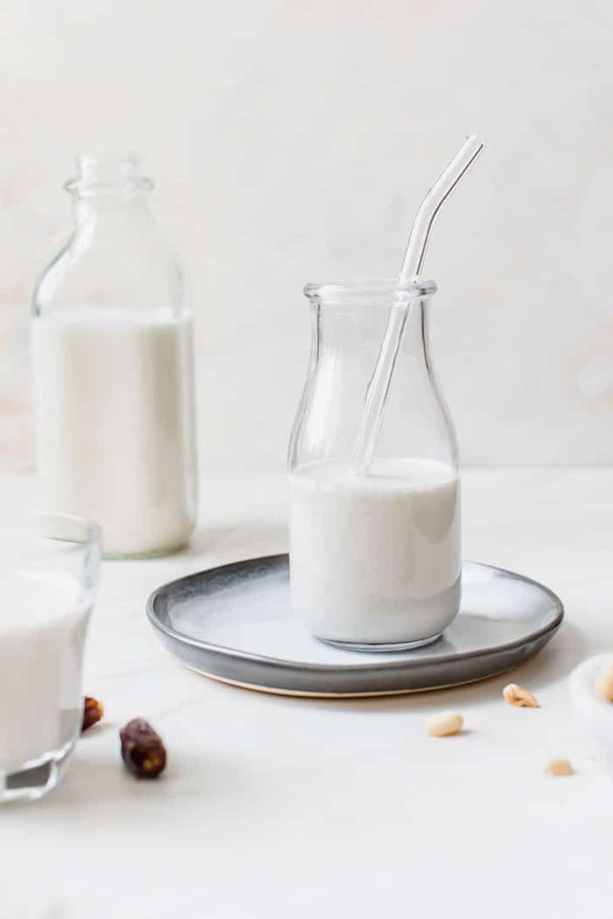homemade milk in a glass jar with a glass straw