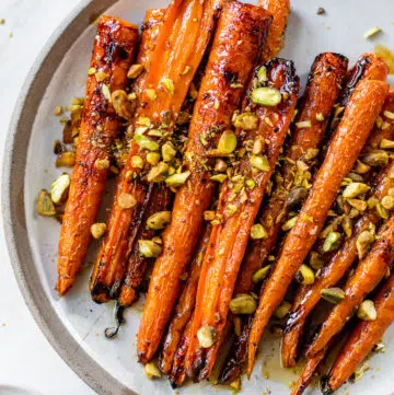 roasted carrots on a plate with pistachios