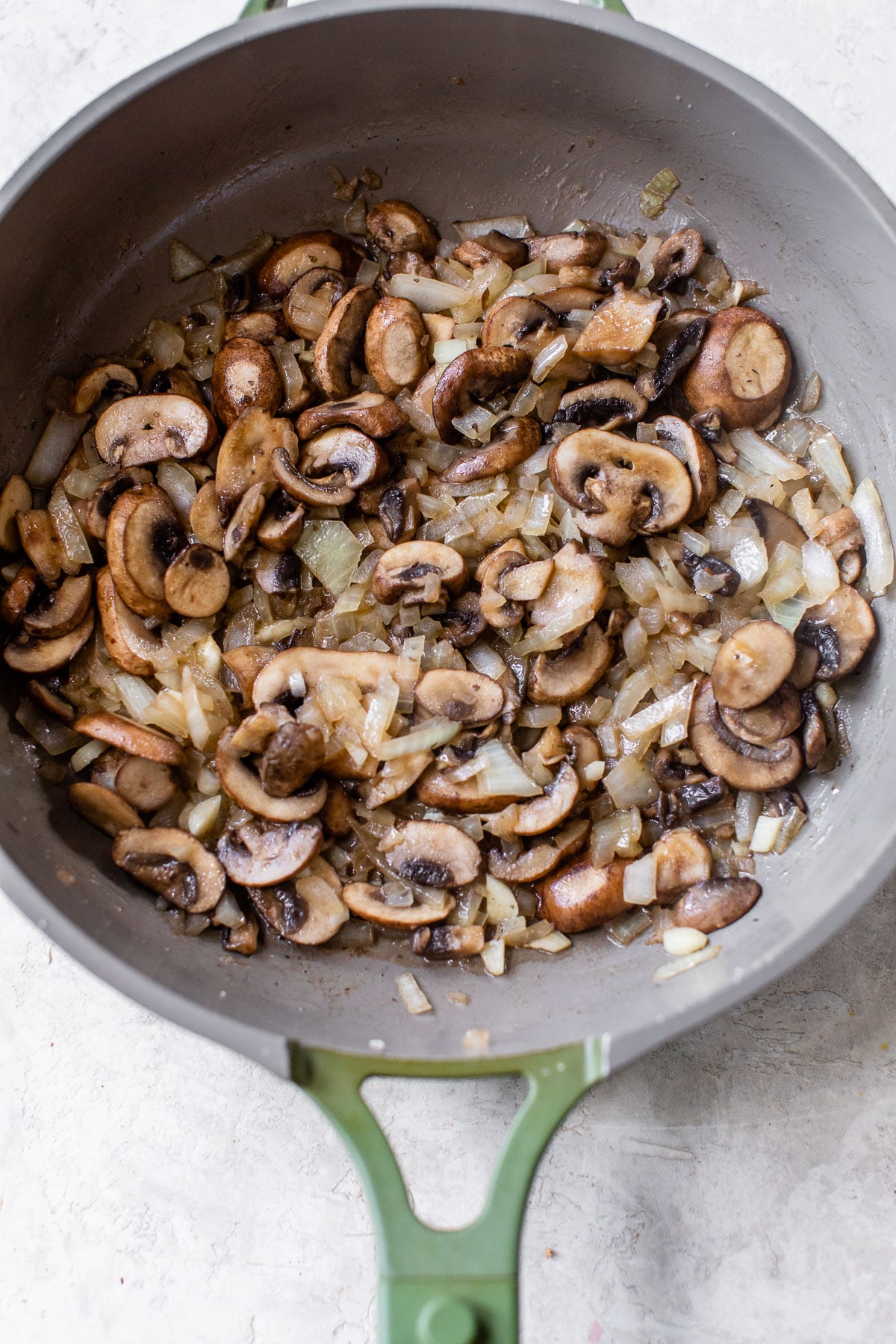 cooked mushrooms and onions in a skillet