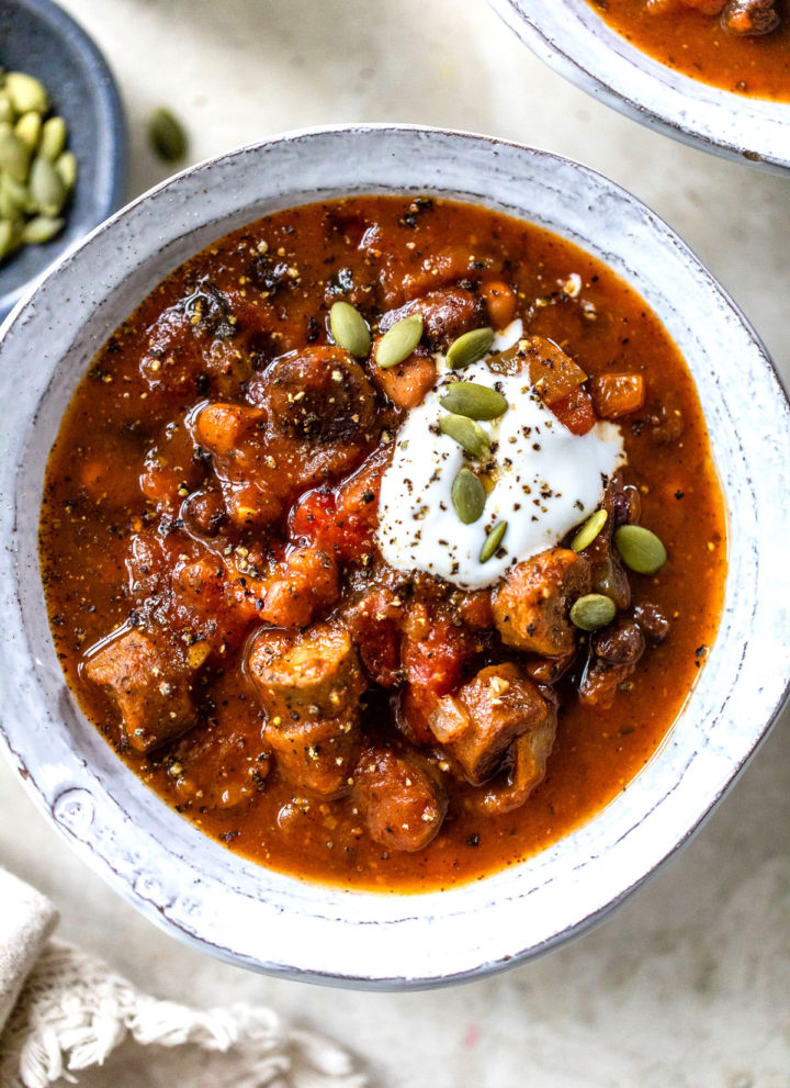 close up photo of a bowl of chili with beans and sausage