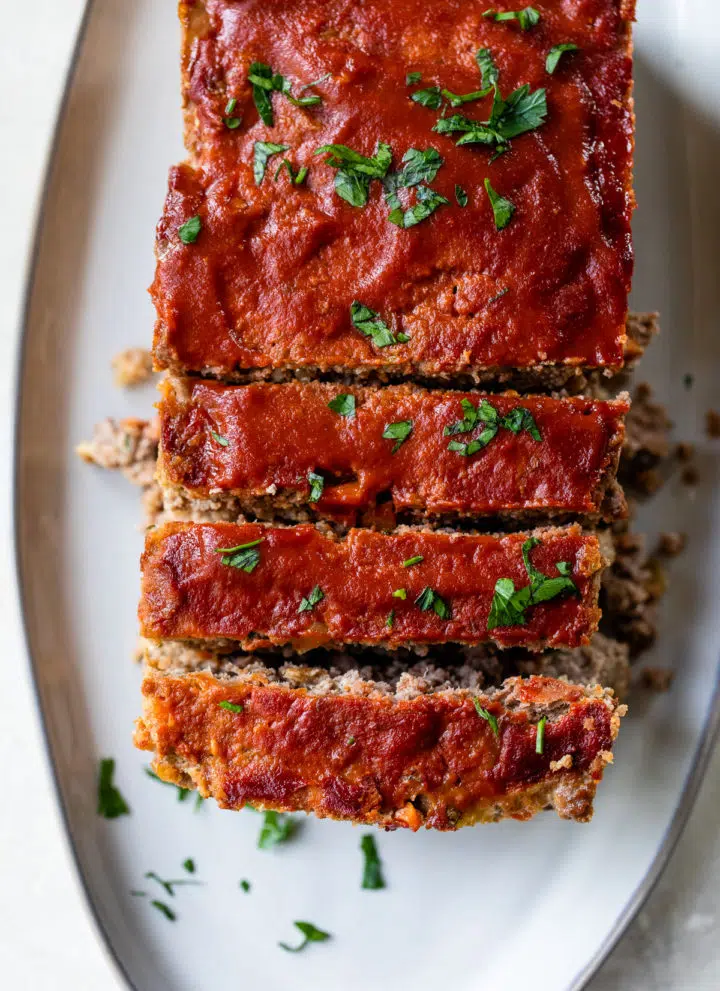 a sliced loaf of meatloaf on a serving platter