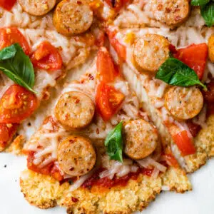 sliced pizza topped with chicken sausage