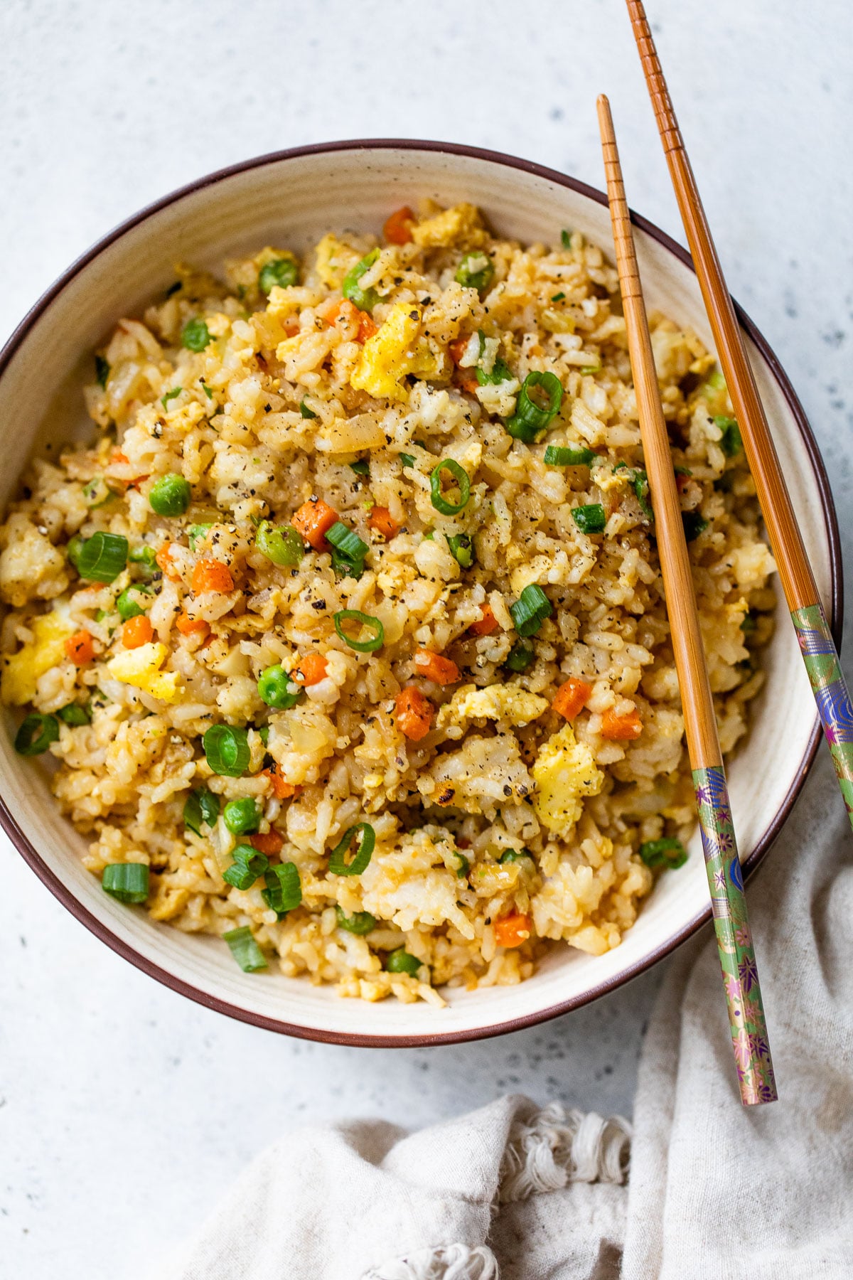 a bowl of fried rice with chopsticks on top