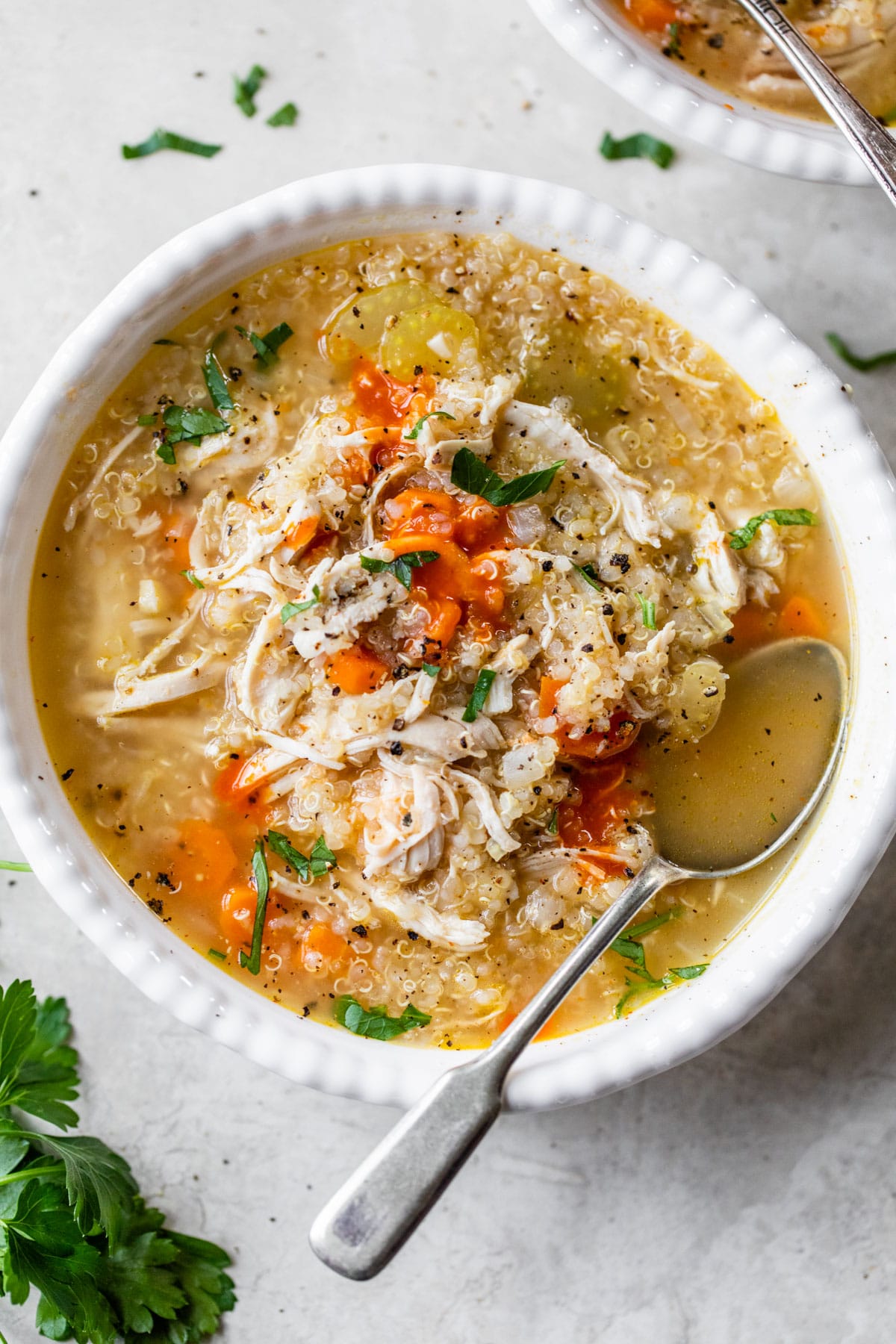 a bowl of soup with shredded chicken and hot sauce