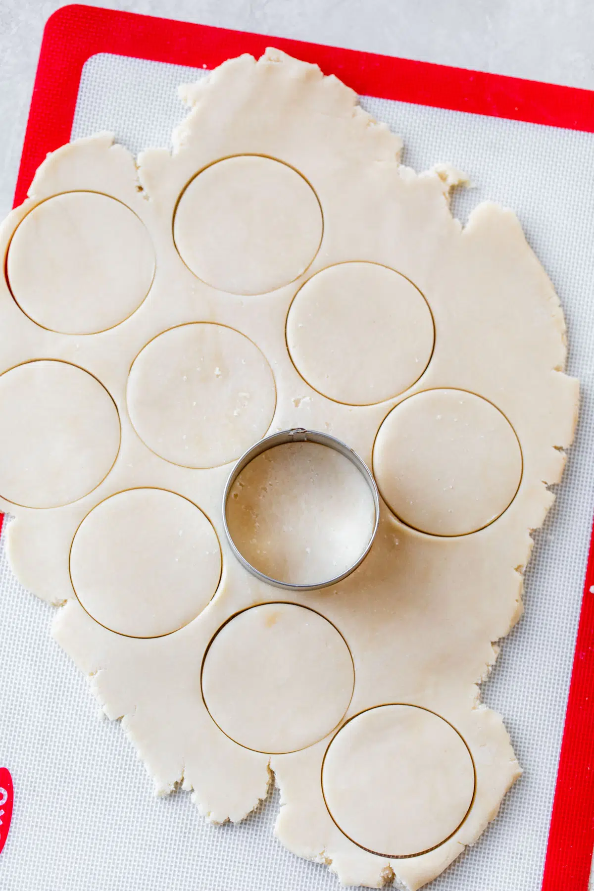rolled out cookie dough with a round cookie cutter on top