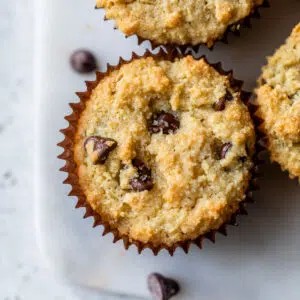 chocolate chip muffins on a marble cutting board
