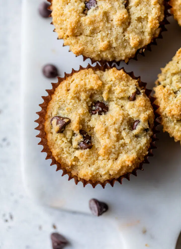 chocolate chip muffins on a marble cutting board