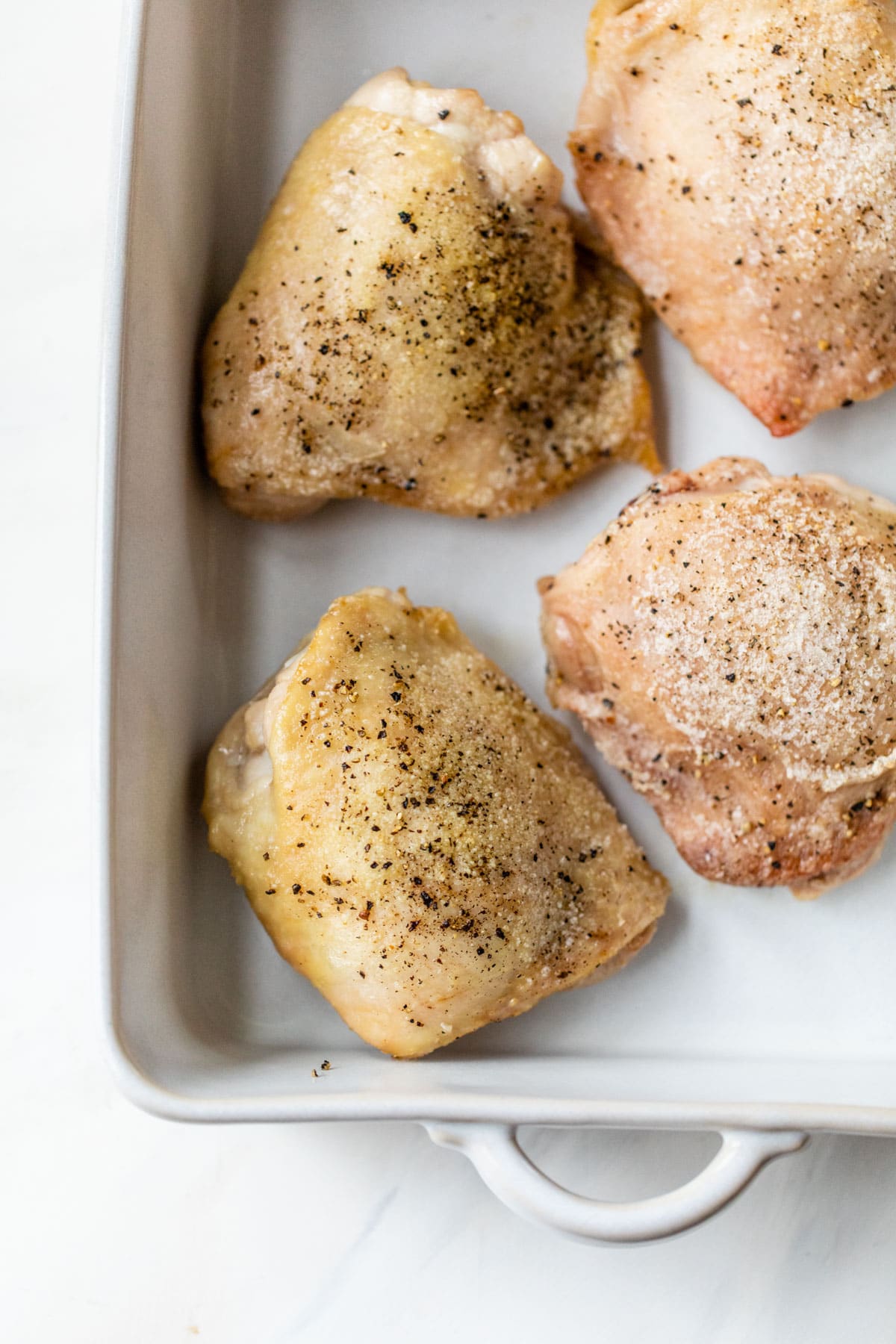 crispy chicken thighs seasoned with salt and pepper