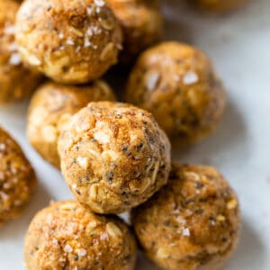 several energy balls made with nut butter and oats on a white plate