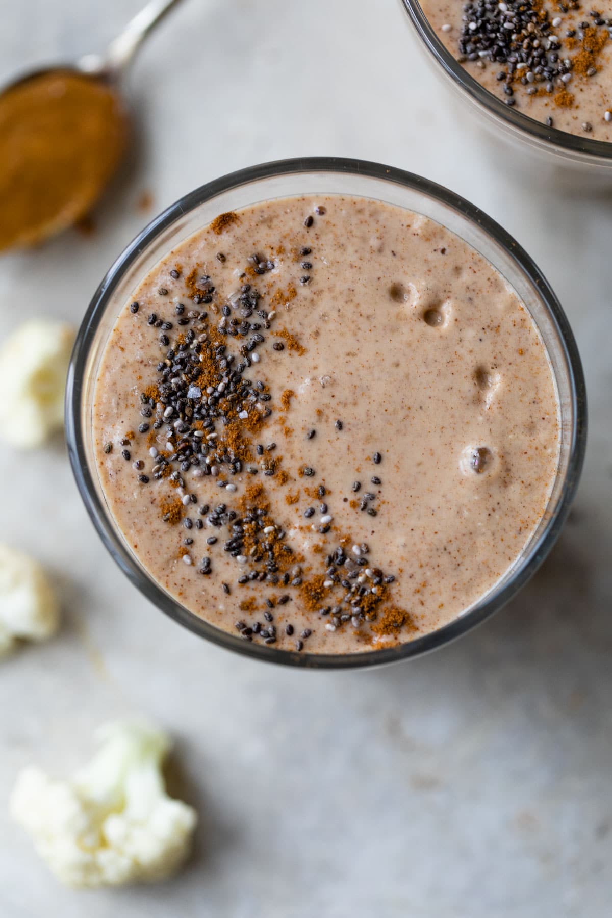 smoothie in a glass topped with cinnamon and chia seeds