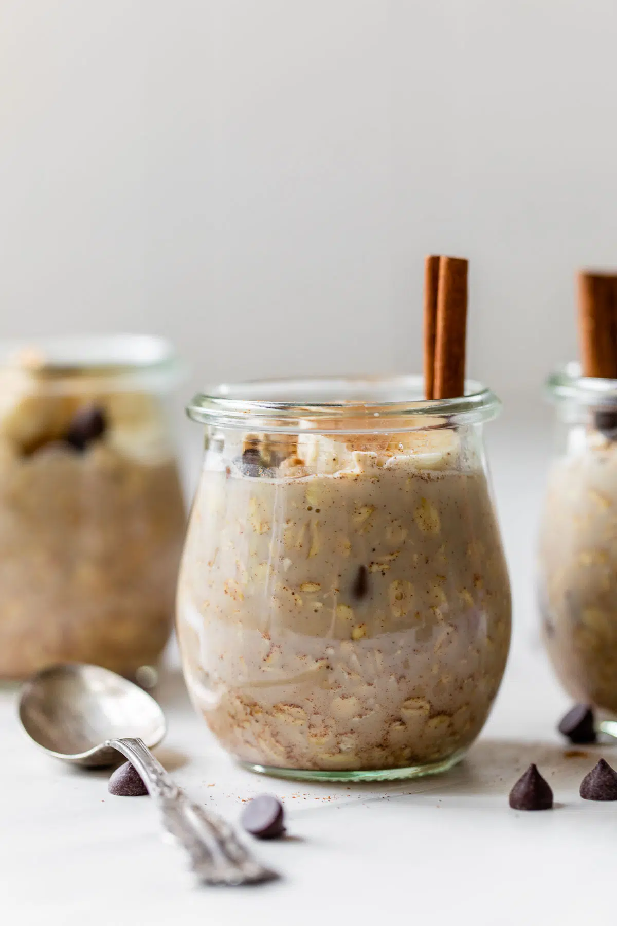 overnight oats in a jar with chocolate chips and a cinnamon stick