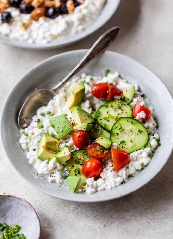 savory bowl of cottage cheese with tomatoes, cucumber and avocado