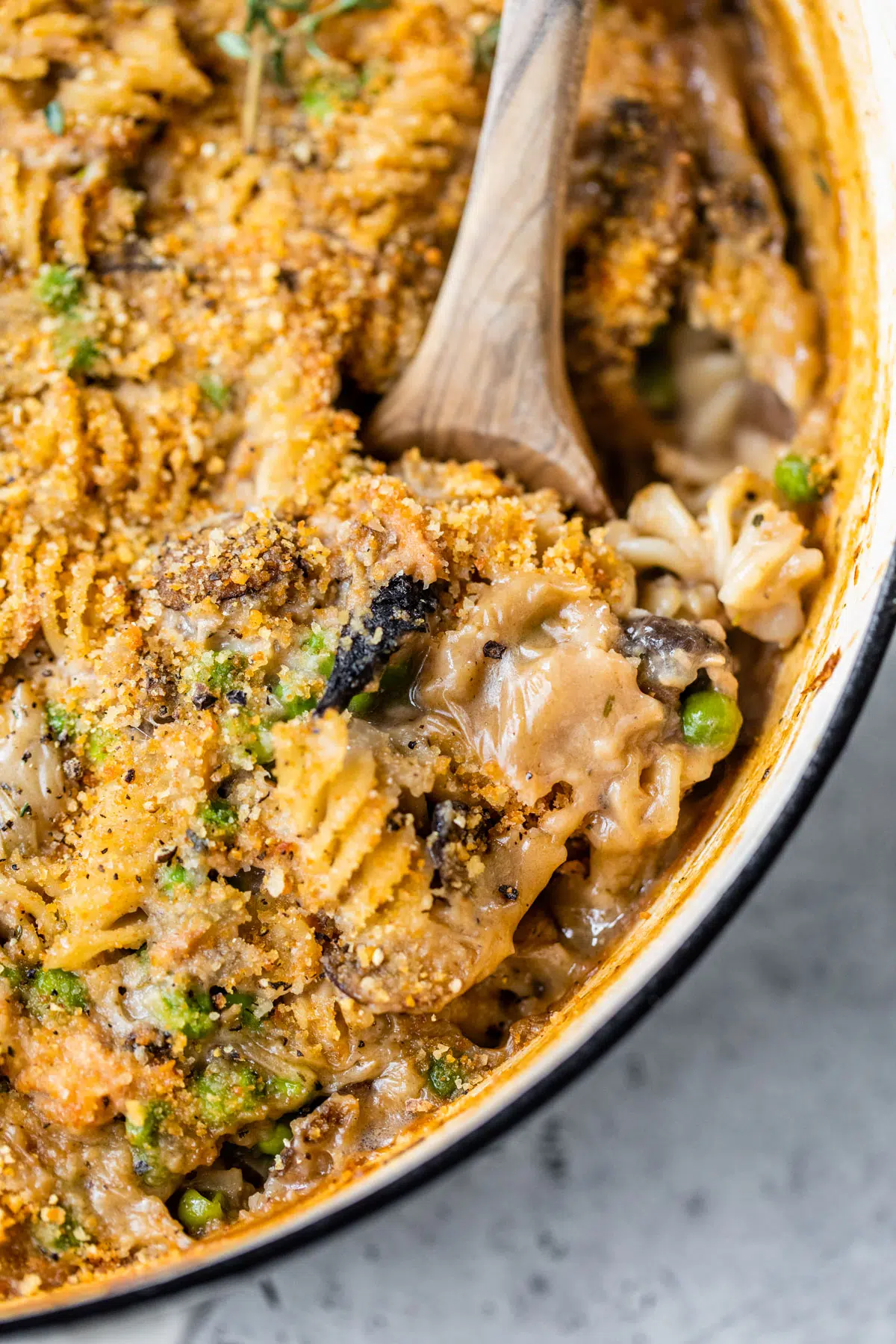 wooden spoon scooping a noodle casserole