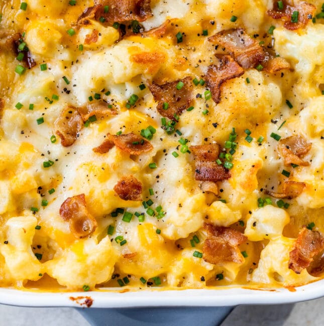 baking dish with cheesy cauliflower, bacon and chives