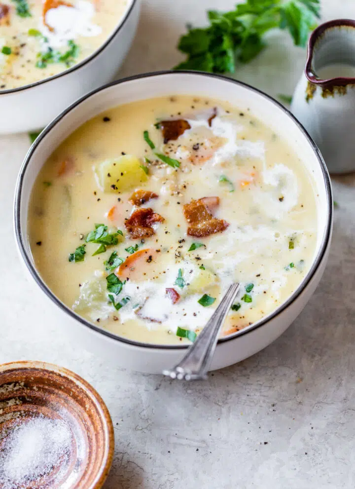 a bowl of creamy potato soup with barley and bacon