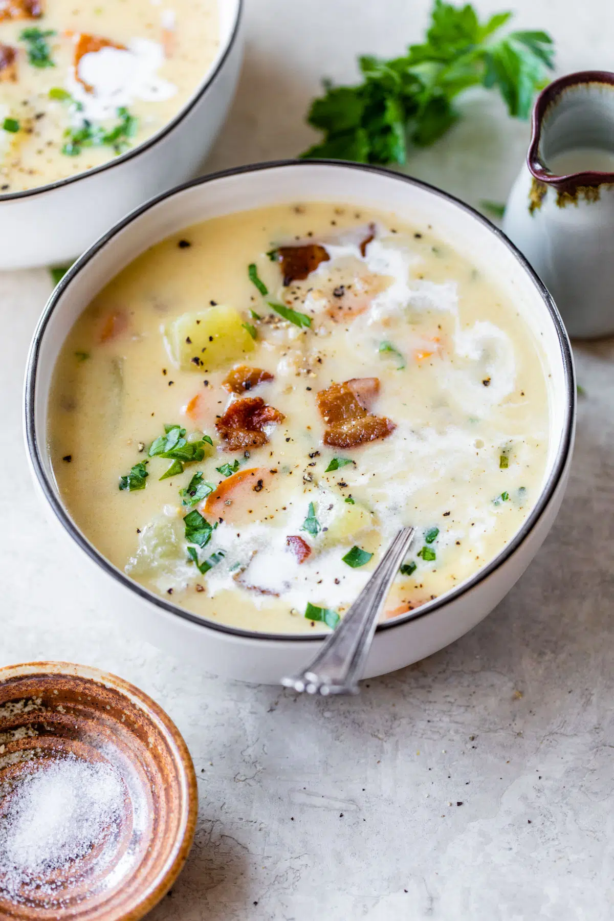 a bowl of creamy potato soup with barley and bacon