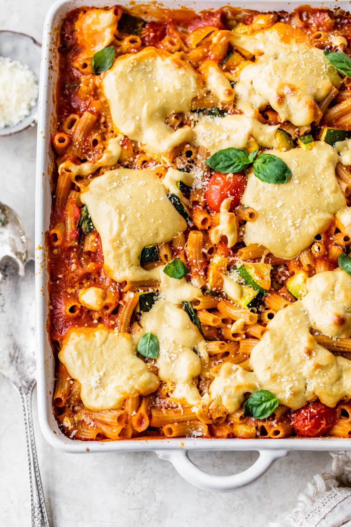 casserole dish filled with pasta, marinara sauce and cheese