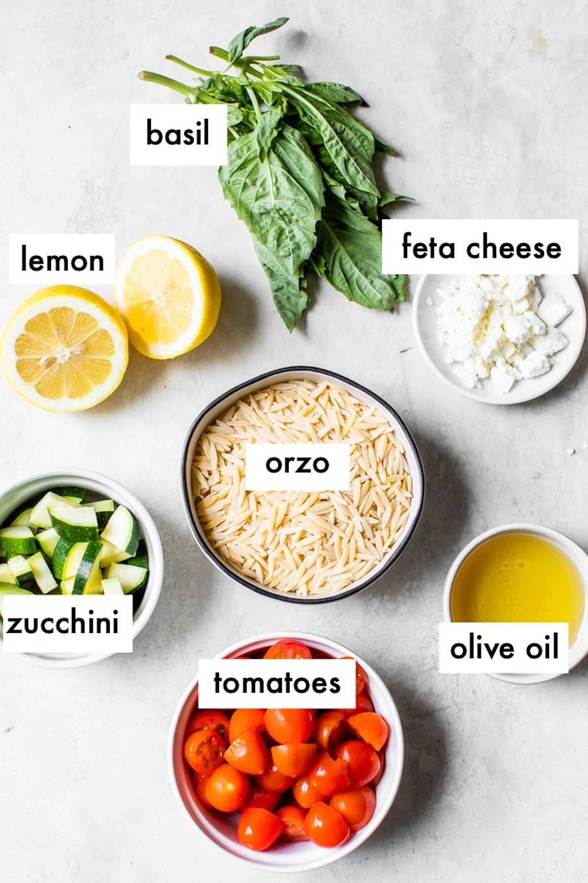 ingredients to make orzo salad like dried orzo, tomatoes and fresh basil