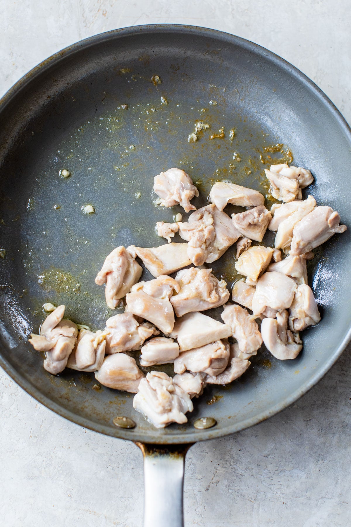 diced cooked chicken in a skillet