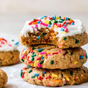 a stack of sprinkle cookies topped with icing