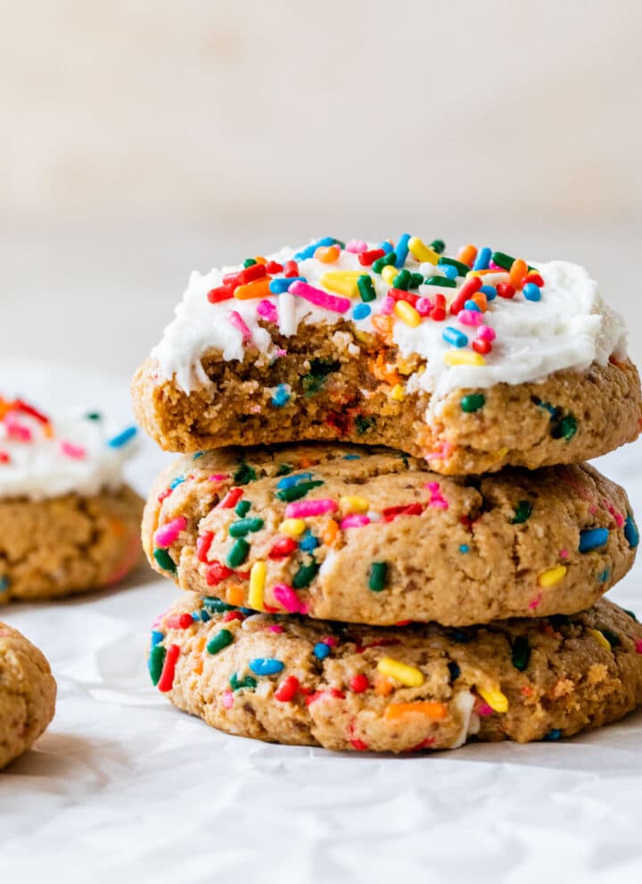 a stack of sprinkle cookies topped with icing