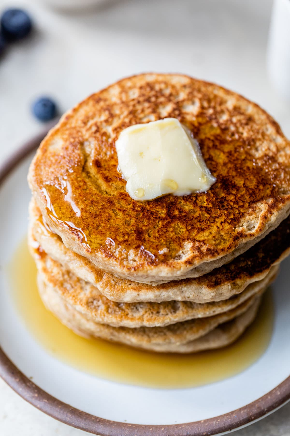 pancakes topped with butter and maple syrup