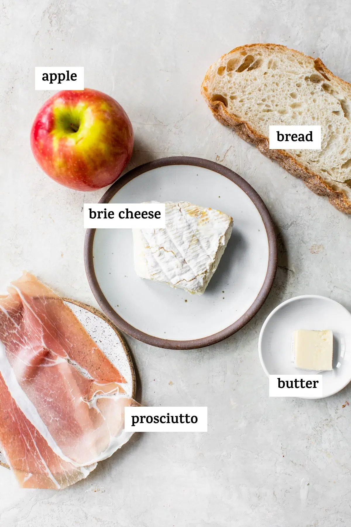 ingredients to make a grilled cheese like brie cheese and an apple
