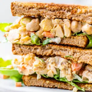 chickpea chicken salad on a sandwich on a plate