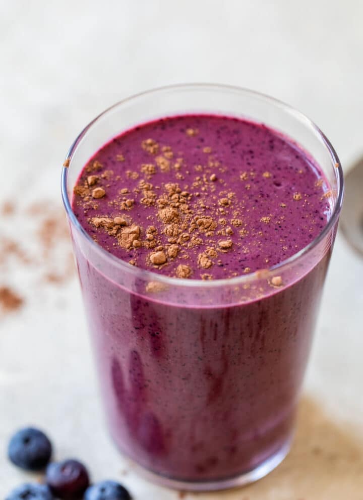 blueberry smoothie topped with cocoa powder